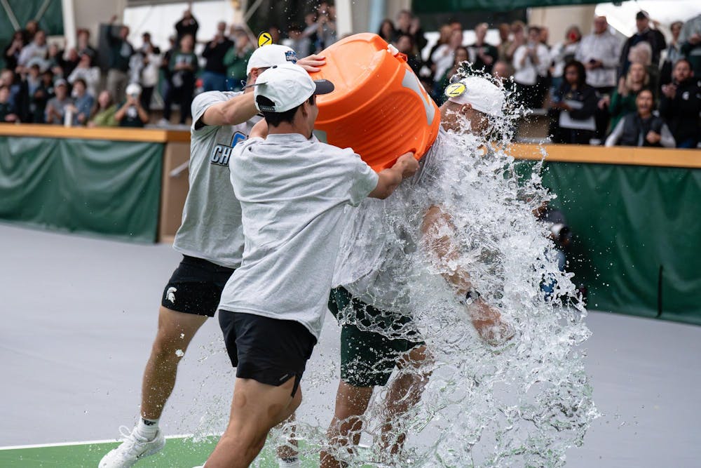 <p>Michigan State head coach Harry Jadun is doused with water from a Gatorade cooler after the Spartans accepted the Big Ten Conference championship trophy at the MSU Tennis Center in Lansing, Michigan, Sunday, April 19, 2026.</p>