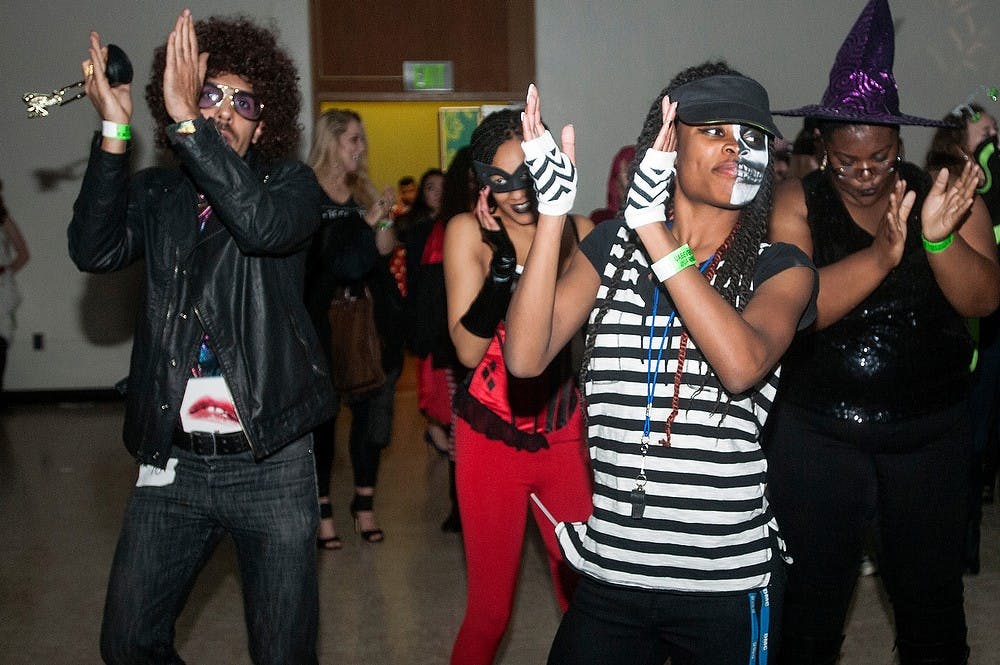 <p>Sociology sophomore Keiarra Menefee dances to music at the Halloween ball on Oct. 31, 2014, at Shaw Hall. The International Students Association and the University Activities Board worked together to host the Halloween ball. Aerika Williams/The State News </p>