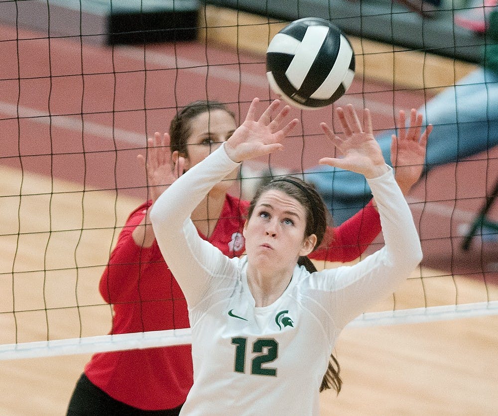 Junior setter Kristen Kelsay attempts to set the ball over the net during the game against Ohio State on Saturday at Jenison Field House. MSU, after losing the game 3-1, is due to play Indiana on Oct. 26. Danyelle Morrow/The State News