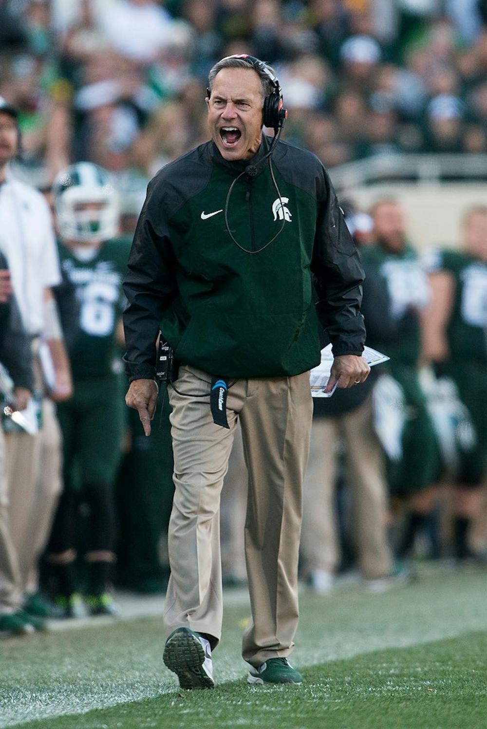 <p>Head coach Mark Dantonio argues a Michigan complete pass call Oct. 25, 2014, at Spartan Stadium. The pass was later ruled incomplete. The Spartans defeated the Wolverines, 35-11. Julia Nagy/The State News</p>