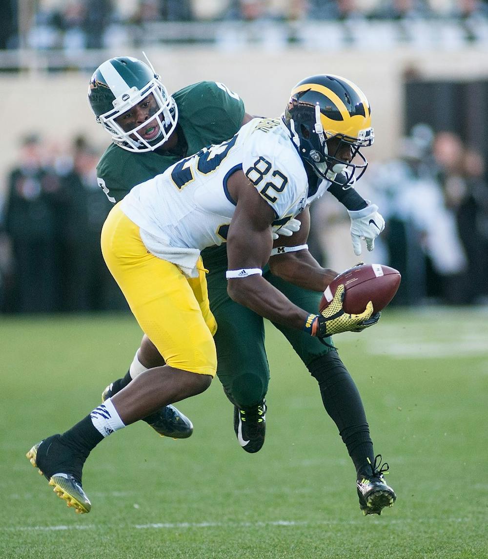 <p>Sophomore cornerback Darian Hicks tackles Michigan wide receiver Amara Darboh on Oct. 25, 2014, at Spartan Stadium. The Spartans defeated the Wolverines, 35-11. Aerika Williams/The State News</p>