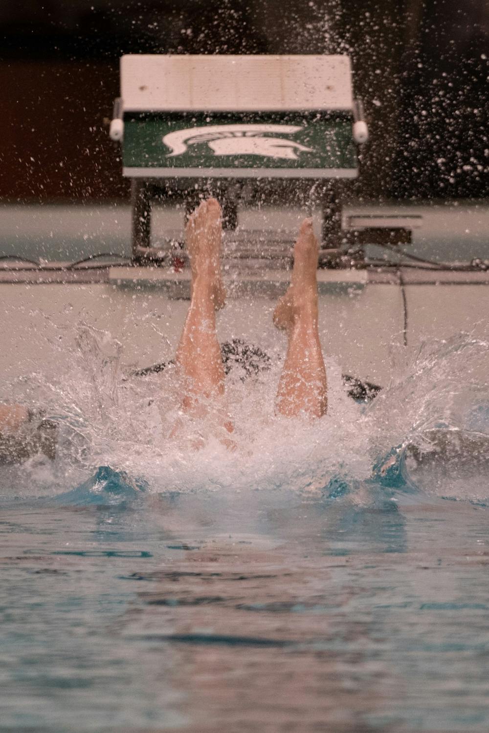 Junior Weston Youngblood enters the pool during the meet against Cleveland State Jan. 24, 2020 at McCaffree Pool. The Spartans defeated the Vikings, 163.5-135.5.
