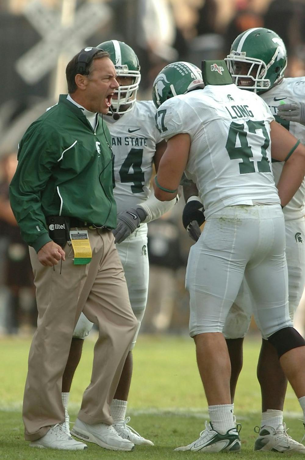 <p>Head coach Mark Dantonio addresses the defense during a timeout in the fourth quarter on Nov. 10, 2007, during the game against Purdue. Jason Chiou/The State News</p>