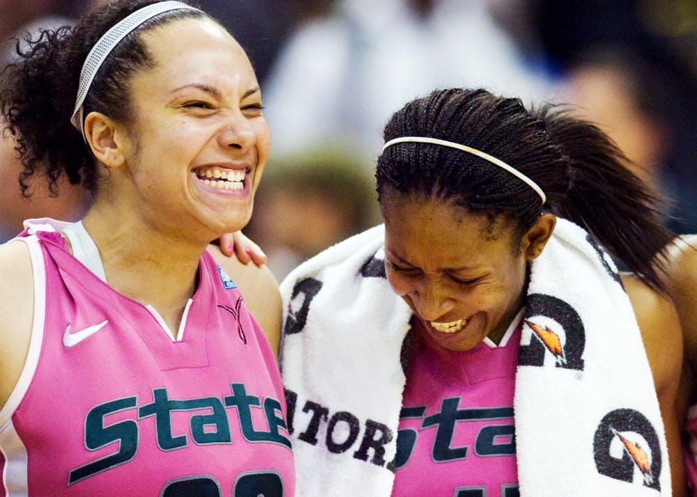 Senior forward Kalisha Keane laughs with senior forward Cetera Washington after defeating Michigan Sunday night at Breslin Center. Keane put up 18 points for the Spartans in their 69-56 victory over the Wolverines. Matt Hallowell/The State News