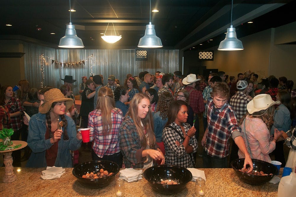 <p>Students mingle before dancing during Barn Bash on Oct. 3, 2014 at the Riverview Church in Lansing, 1115 Washington Street. Barn Bash was put on by MSU Cru, a student organization that connects people to Jesus Christ. Jessalyn Tamez/The State News </p>
