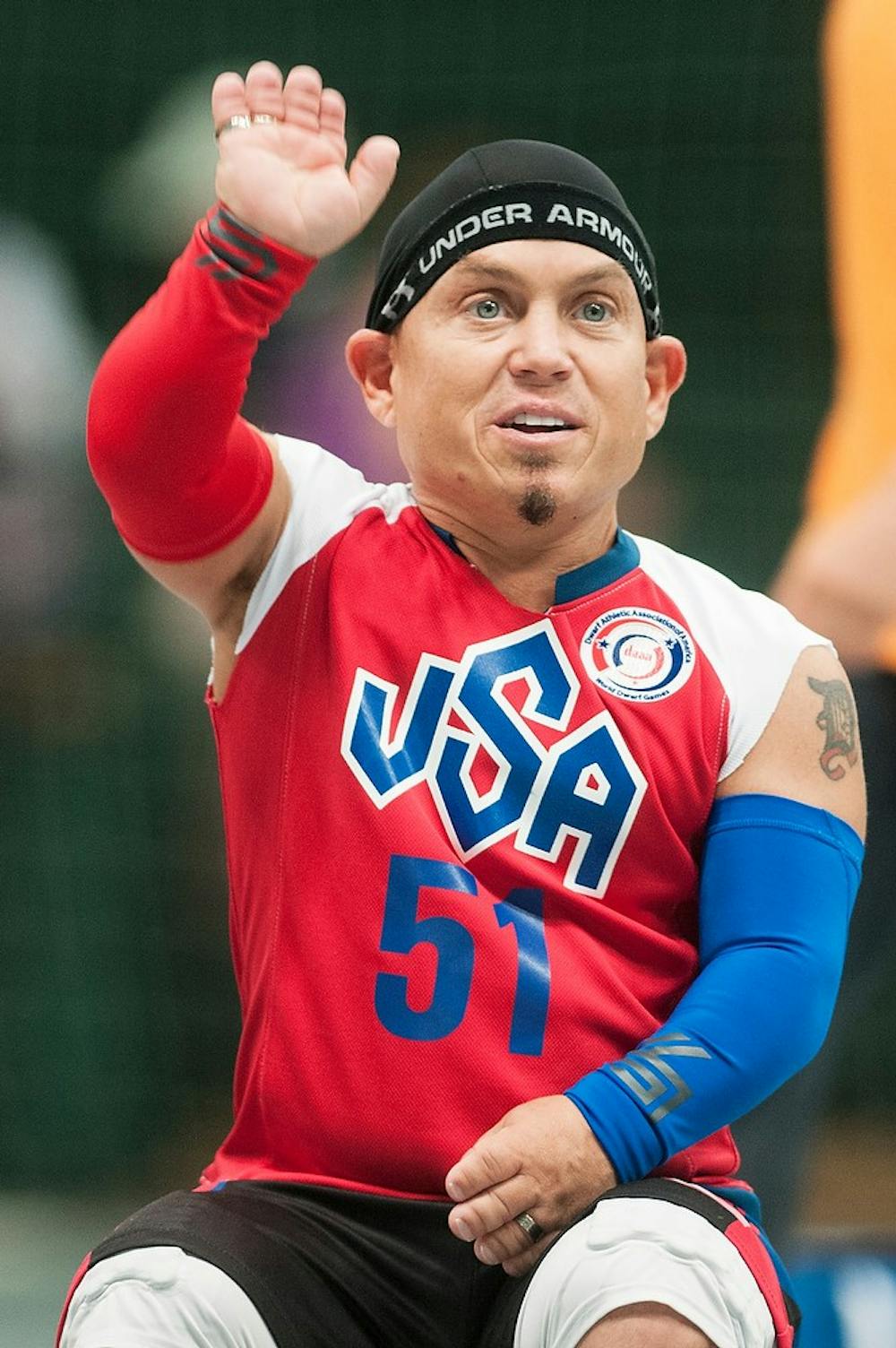 	<p>Troy, Mich. resident Martin Klebba waves at teammates from the sidelines during a volleyball set of the 2013 World Dwarf Games, August 8, 2013, at Jenison Field House. An actor known for his role in Pirates of the Caribbean, Klebba represented the <span class="caps">USA</span> team, &#8220;The Statesmen.&#8221; Danyelle Morrow/The State News</p>