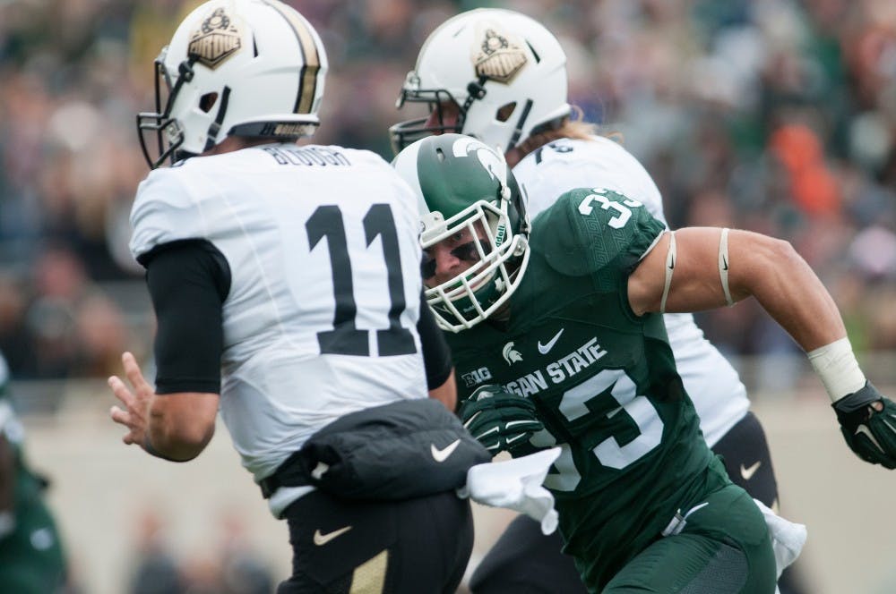 <p>Sophomore linebacker Jon Reschke chases after Purdue quarterback David Blough in the first quarter during the Homecoming game against Purdue on Oct. 3, 2015 at Spartan Stadium. The Spartans defeated the Boilermakers, 24-21.</p>