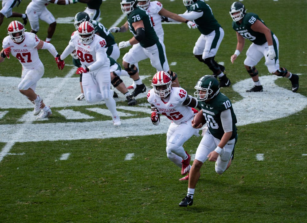 <p>MSU quarterback Payton Thorne (10) carries the ball for MSU in a game against Indiana University in Spartan Stadium on Nov. 14, 2020.</p>