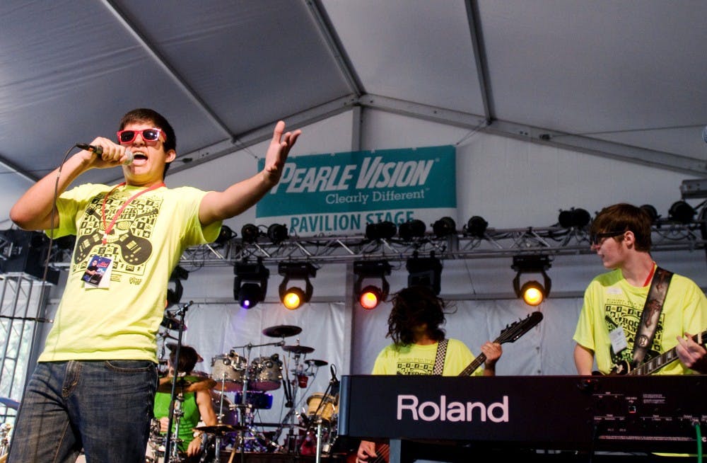 	<p>Front man Eric Locker, 14, an Owosso resident, belts out a Nirvana tune while members of his band, Bancroft, Mich., resident Dan Post, 15, center, and Lansing resident Chris Milbourne, 17, accompany him on guitar Friday at Common Ground Music Festival in Lansing. The boys&#8217; band, Voltage, performed at the music festival with other bands from the <span class="caps">MSU</span> Community Music School&#8217;s &#8220;Rock Camp&#8221;, which was held the week before their performances. </p>