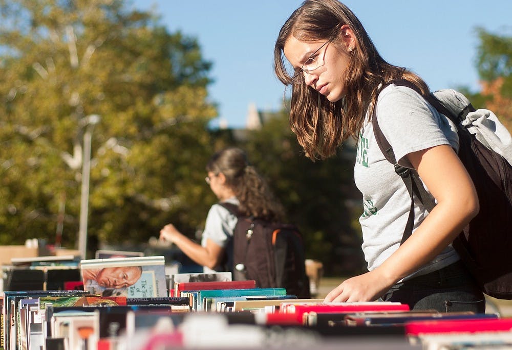 	<p>Engineering freshman Camila Chiles searches through the available books at a book sale on Farm Lane, Sept. 26, 2013. The book sale was held by <span class="caps">MSU</span>&#8217;s Center for Poetry as a fundraiser to enhance their program. Brian Palmer/ The State News</p>