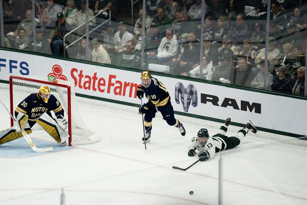 <p>Notre Dame senior forward Hunter Strand (10) skates to the puck after Michigan State junior forward Tiernan Shoudy (13) falls on the ice at Munn Ice Arena on March 15, 2025. The Spartans took a 1-0 victory over the Fighting Irish, advancing to the Big Ten Championship.</p>