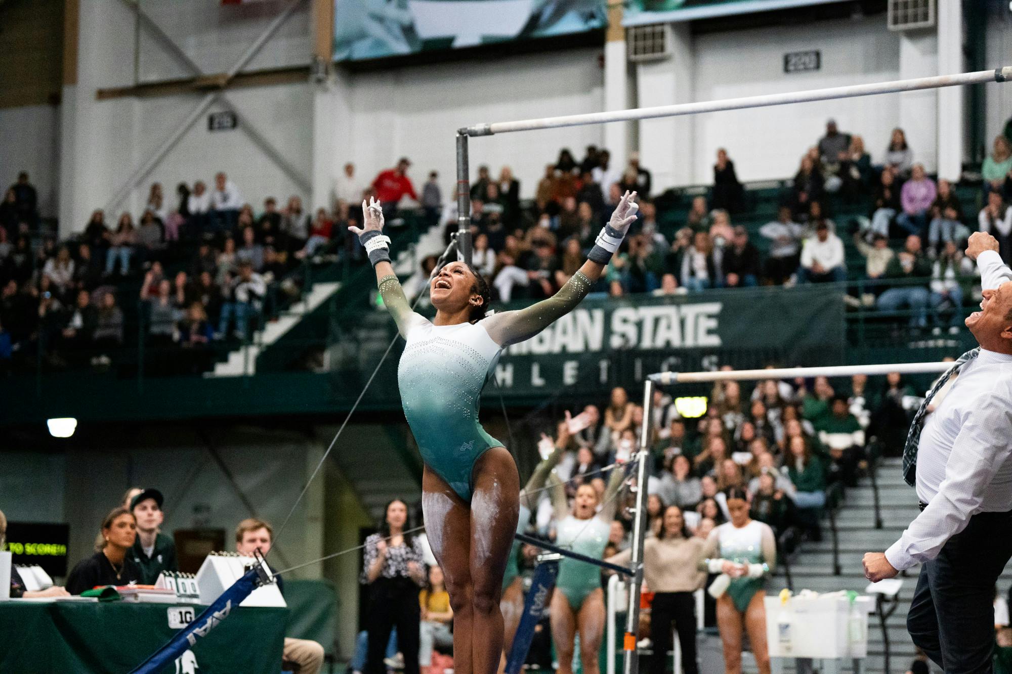 <p>Freshman All-Around Nikki Smith after finishing her dismount on the uneven bars at the MSU vs. Penn State meet at the Jenison Field House on Feb. 4, 2023. The Spartans beat the Nittany Lions 197.450 - 195.475.</p>