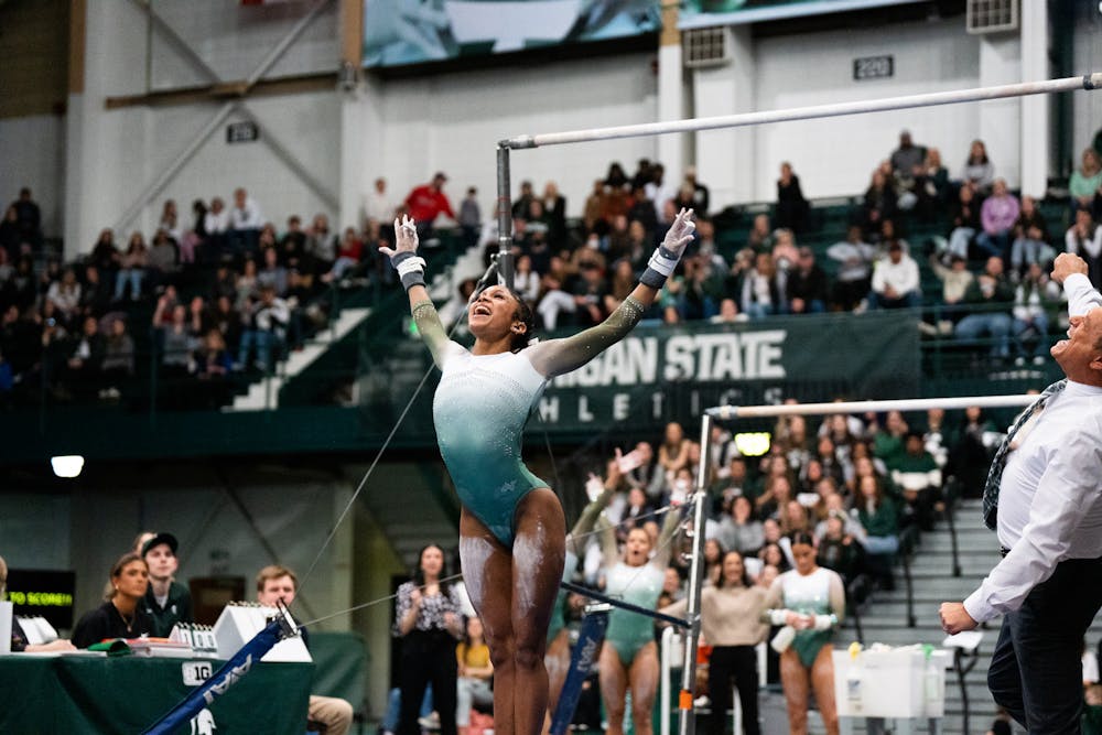 <p>Freshman All-Around Nikki Smith after finishing her dismount on the uneven bars at the MSU vs. Penn State meet at the Jenison Field House on Feb. 4, 2023. The Spartans beat the Nittany Lions 197.450 - 195.475.</p>