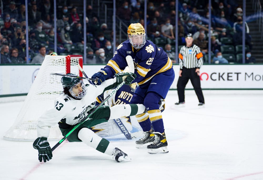 <p>Notre Dame graduate student Jack Adams checking Michigan State junior Jagger Joshua on Feb. 19, 2022. Spartans lost 4-2 against Notre Dame.</p>