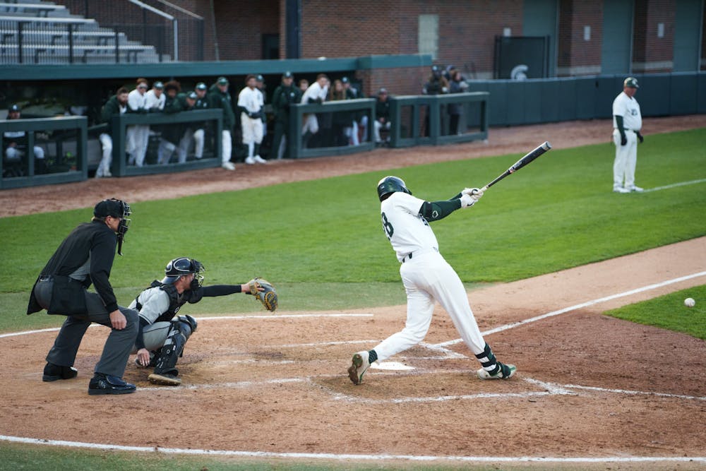 <p>Michigan State sophomore infielder Brock Vradenburg (28) singling to first base in the bottom of the fifth. Michigan State won 7-4 against Purdue Fort Wayne at the McLane Stadium, on Apr. 27, 2022.</p>