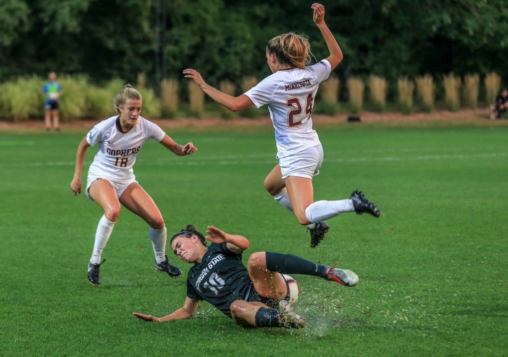 Minnesota’s defense Marisa Windingstad (24), leaps over freshman forward Camryn Evans (10), during the game against Minnesota at DeMartin Stadium on Sept. 20, 2018. The Spartans and Gophers tied in double overtime, 0-0.