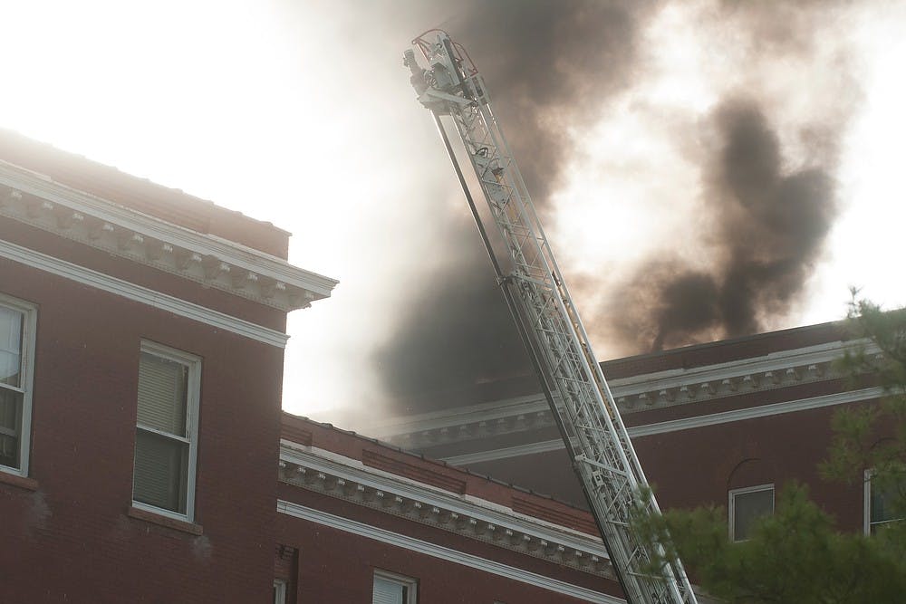 	<p>Fire fighters respond to a fire May 15, 2013, at Morrill Hall. The cause of the fire is still unknown. Weston Brooks/The State News</p>