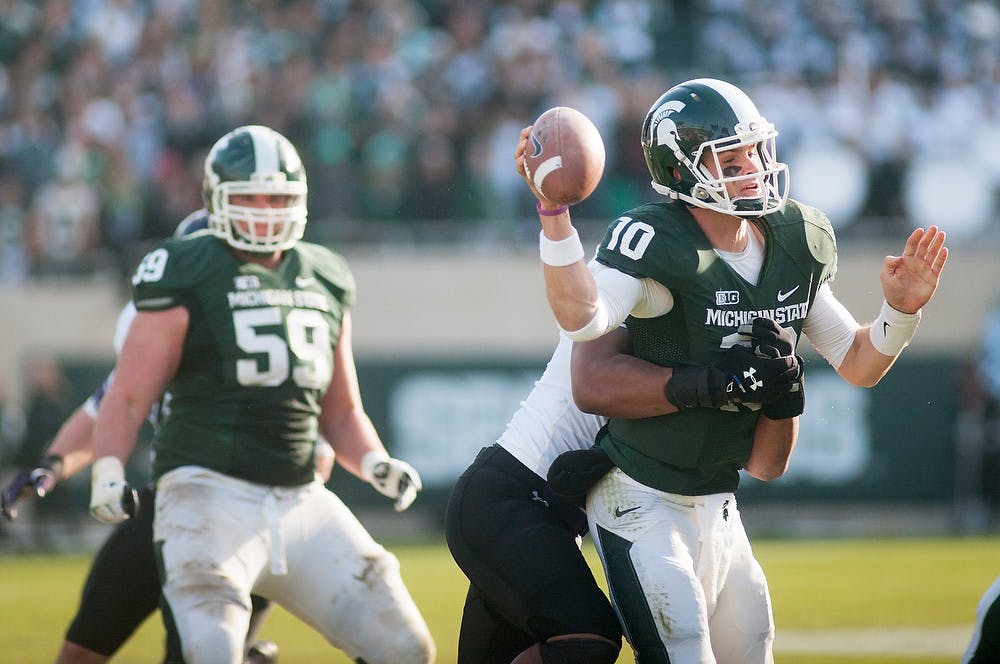 	<p>Junior quarterback Andrew Maxwell gets sacked by Northwestern linebacker Chi Chi Ariguzo on Saturday, Nov. 17, 2012, at Spartan Stadium. Maxwell was sacked three times in the Spartans&#8217; 23-20 loss to Northwestern. James Ristau/The State News</p>