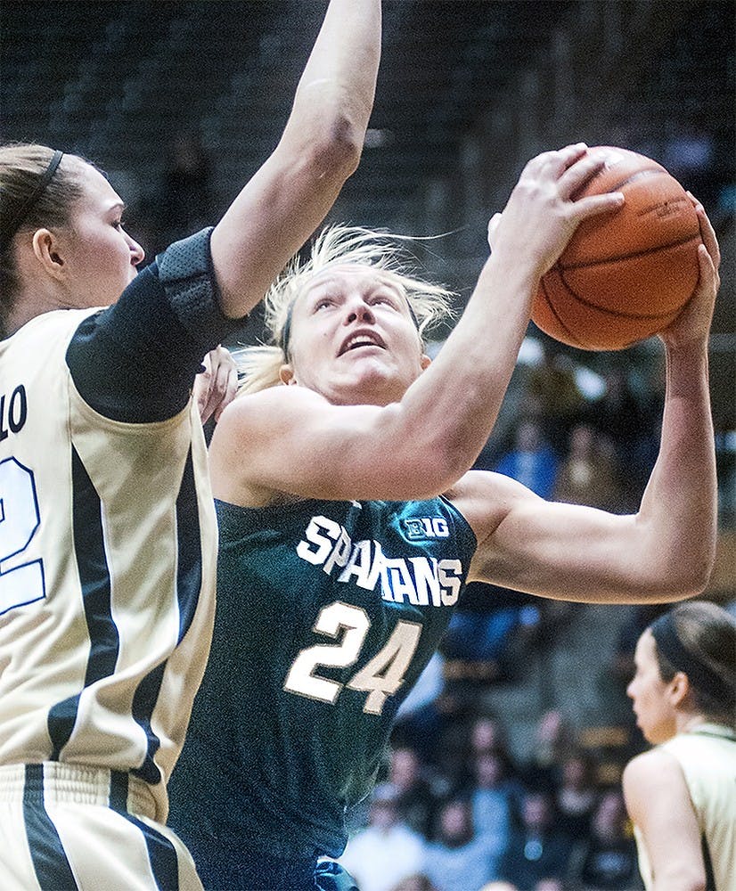 Senior forward Courtney Schiffauer tries to score around Purdue forward Sam Ostarello during the game on Thursday, Feb. 28, 2013, at Mackey Arena in West Lafayette, Indiana. The MSU Spartans beat the Purdue Boilermakers 68-61. Danyelle Morrow/The State News