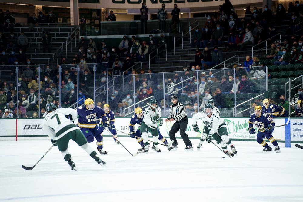 <p>Michigan State senior Mitchell Lewandowski with the puck looking to take the puck up the rink at the start of first period on Feb. 18, 2022. Spartans lost 2-1 against Notre Dame.<br/><br/><br/><br/></p>