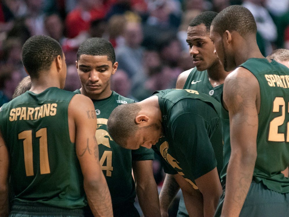 	<p>Members of the <span class="caps">MSU</span> men&#8217;s basketball team gather together during the final moments of the semifinal round of the Big Ten Tournament against Ohio State on March 16, 2013, at United Center in Chicago, Ill. The Buckeyes beat the Spartans, 61-58. Natalie Kolb/The State News</p>