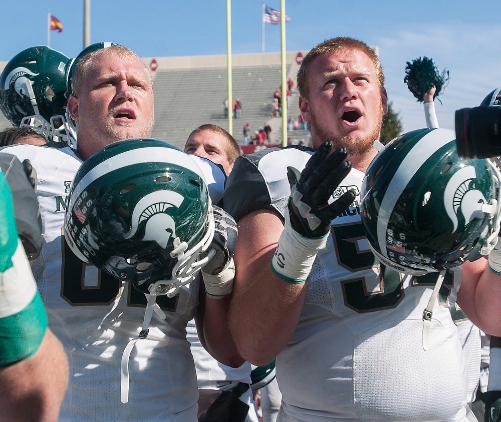 	<p>Senior offensive guard Chris McDonald and sophomore offensive guard Connor Kruse chant the <span class="caps">MSU</span> fight song after the game Saturday, Oct. 6, 2012, at Memorial Stadium in Bloomington, Ind. Despite trailing to Indiana at half-time, the Spartans were able to earn the 31-27 victory. Adam Toolin/The State News</p>