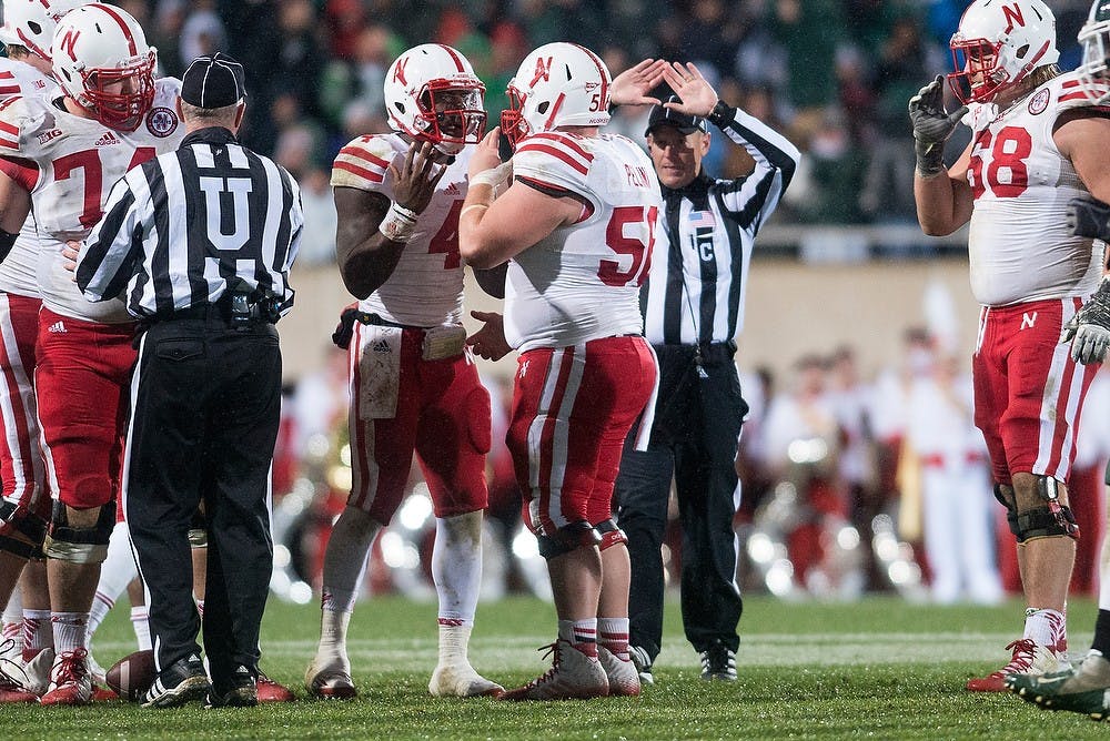 <p>Nebraska quarterback Tommy Armstrong Jr. talks to offensive lineman Mark Pelini on Oct. 4, 2014, at Spartan Stadium. The Spartans defeated the Huskers, 27-22. Julia Nagy/The State News</p>