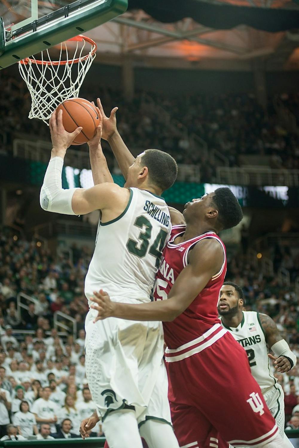 <p>Sophomore forward Gavin Schilling goes for a basket against Indiana forward Emmitt Holt Jan. 5, 2014, during the game against Indiana at Breslin Center. The Spartans defeated the Hoosiers, 70-50. Erin Hampton/The State News</p>