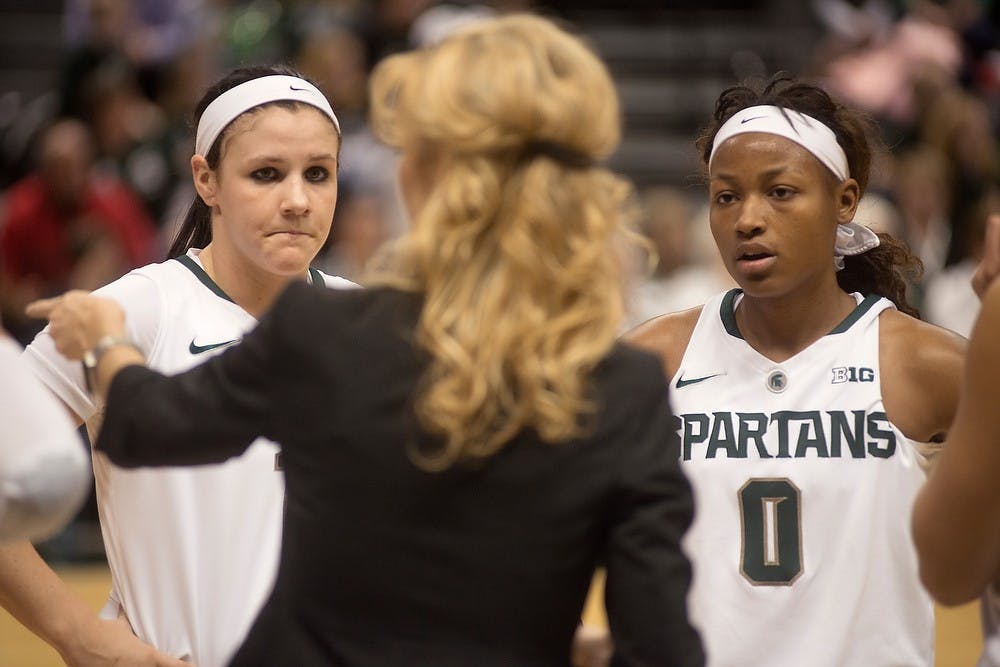 	<p>Freshman guard Tori Jankoska, left, and junior guard Kiana Johnson listen to head coach Suzy Merchant on Feb. 2, 2014, Breslin Center during the game against Purdue. The Spartans defeated the Boilermakers, 89-73. Julia Nagy/The State News</p>