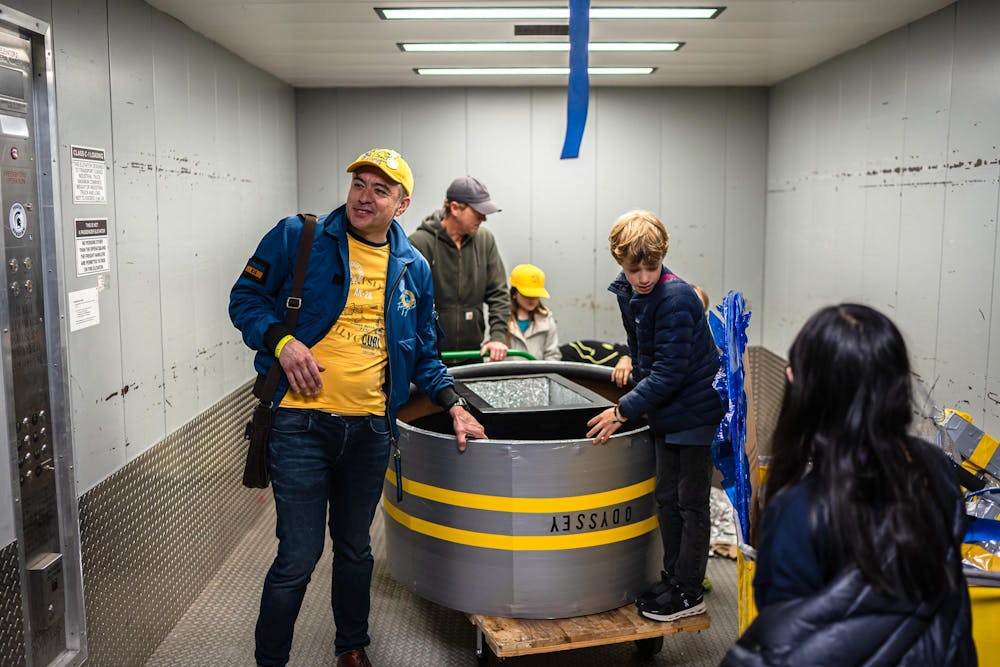 Odyssey of the Minds competitors from Wisconsin move their OM-Mazing Race vehicle through the Jack Breslin Center in East Lansing, Michigan on May 22, 2025. 