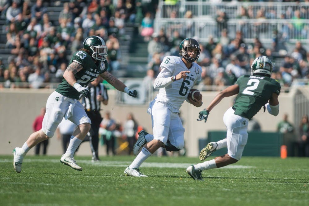 Senior quarterback Damion Terry (6) runs with the football during the Green and White scrimmage on April 23, 2015 at Spartan Stadium. The White team defeated the Green team, 14-11.