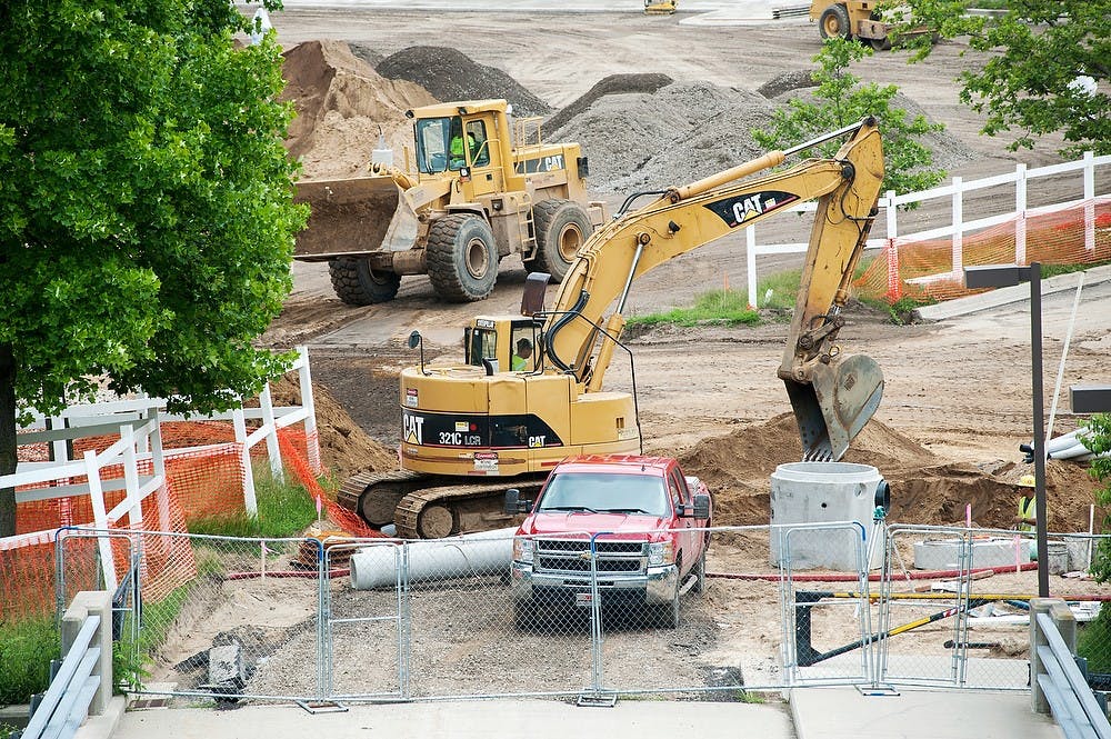 	<p>Construction continues at Lot 67 near Jenison Field House, July 2, 2013. The parking lot is currently undergoing facility upgrades, and will reopen in mid-August. Justin Wan/The State News</p>
