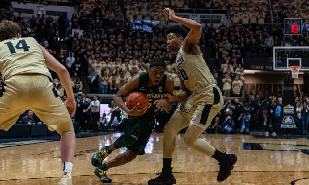 Junior guard Cassius Winston (5) drives on Purdue's Nojel Eastern at Mackey Arena on Jan. 27, 2019. The Spartans fell to the Boilermakers 73-63.