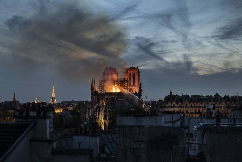 Smoke and flames rise from Notre-Dame Cathedral on April 15, 2019 in Paris, France. A fire broke out on Monday afternoon and quickly spread across the building, collapsing the spire. The cause is yet unknown but officials said it was possibly linked to ongoing renovation work. (Veronique de Viguerie/Getty Images/TNS) 
