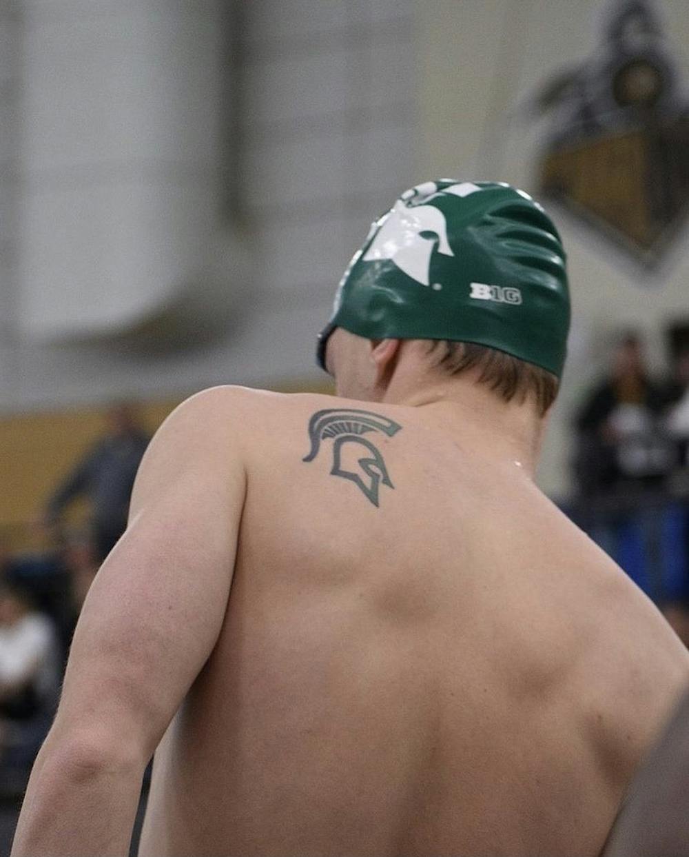 Phillip Meffert prepares for one of his events during a swim meet while in college. Meffert is a senior, the tattoo on his left shoulder is a long-time tradition for members of the Swim & Dive program to get while competing for Michigan State. (Credit: Phillip Meffert / Courtesy)