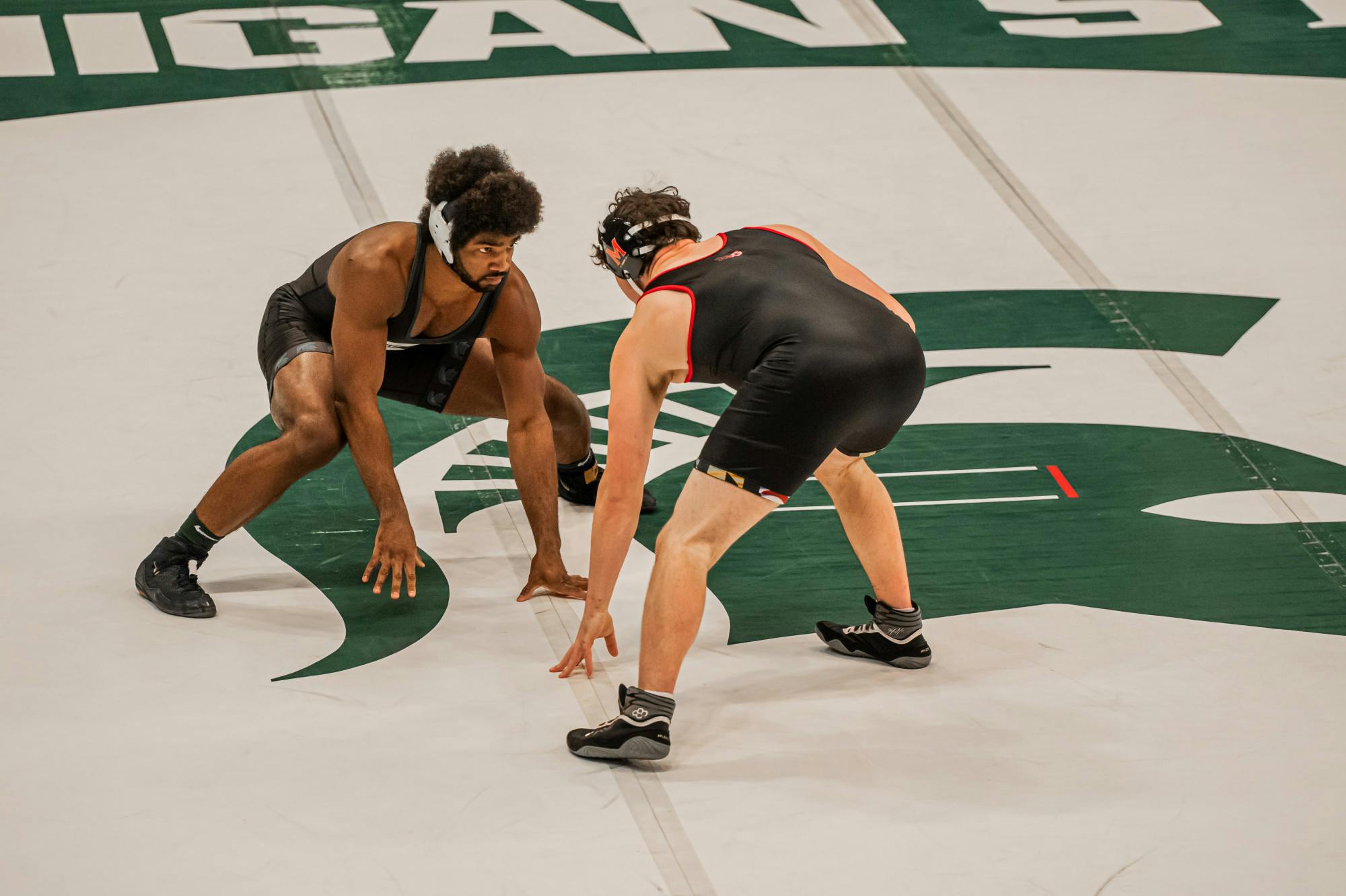 <p>Redshirt junior Cameron Caffey stares down redshirt freshman Kevin Makosy in his first match of the season Jan. 16, 2021. Caffey won the match, 14-4.</p>