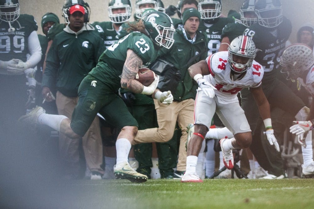 Junior linebacker Chris Frey (23) runs a punt fake for a first down in the game against Ohio State on Nov. 19, 2016 at Spartan Stadium. The Spartans were defeated by the Buckeyes, 17-16.