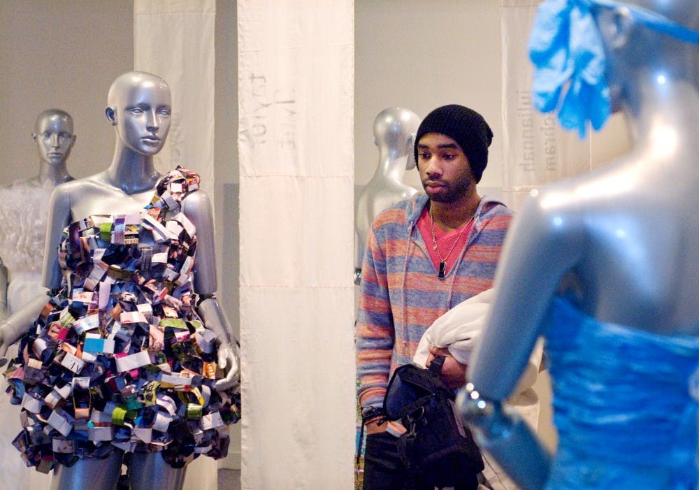 	<p>Holt, Mich., resident Jamal Knox reads the designer’s statement while walking through the re:Dress Exhibition Wednesday at the <span class="caps">MSU</span> Museum.</p>