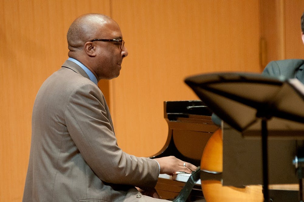 <p>Associate professor of Jazz Piano Xavier Davis plays Sept. 22, 2014, at the Bryan and Dolores Cook Recital Hall. Raymond Williams/The State News</p>