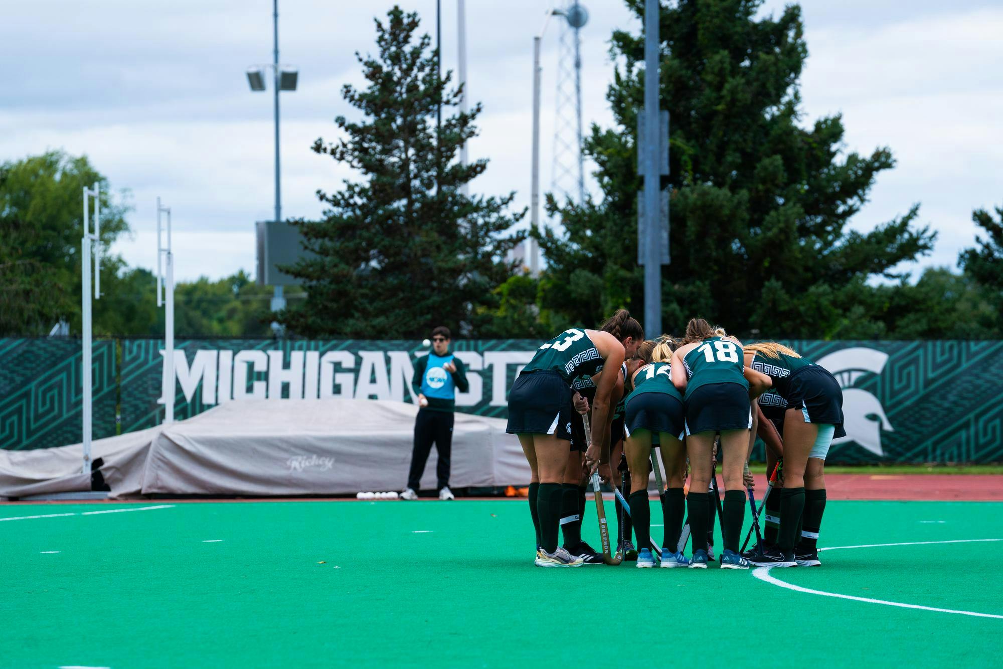 <p>Members of the Michigan State University Field Hockey team huddle up during a match against the University of Vermont at Ralph Young Field on Sep. 6, 2024.</p>