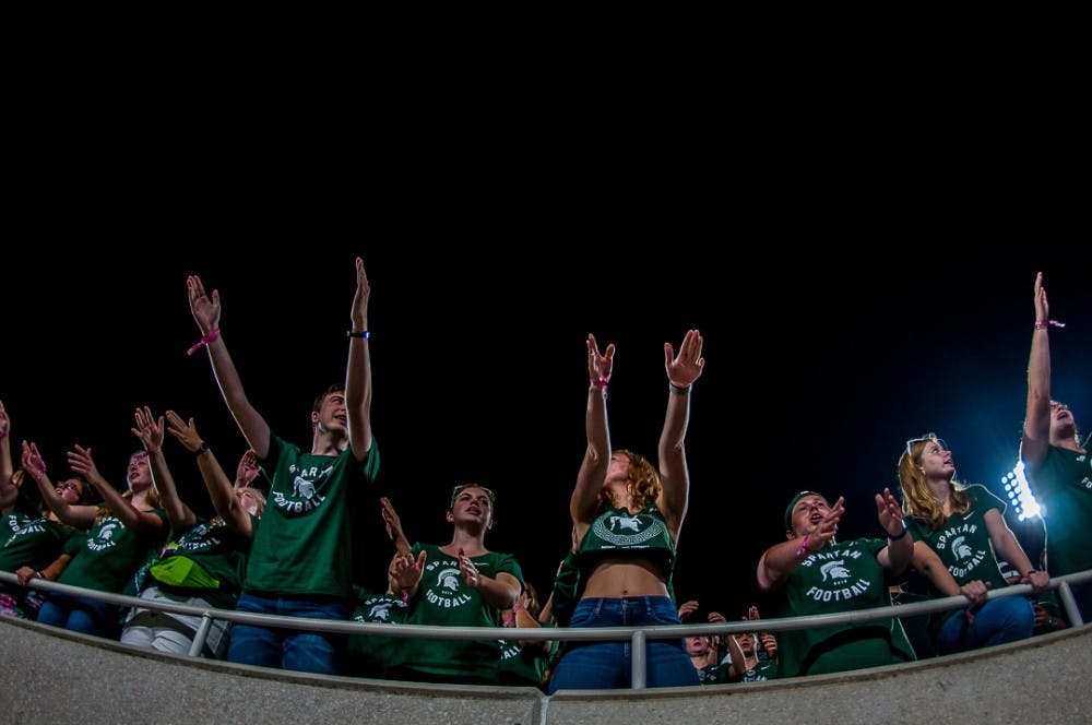 The student section chants "Go green, Go white" during the fourth quarter of the game against Utah State on Aug. 31, 2018 at Spartan Stadium. The Spartans beat the Aggies, 38-31.