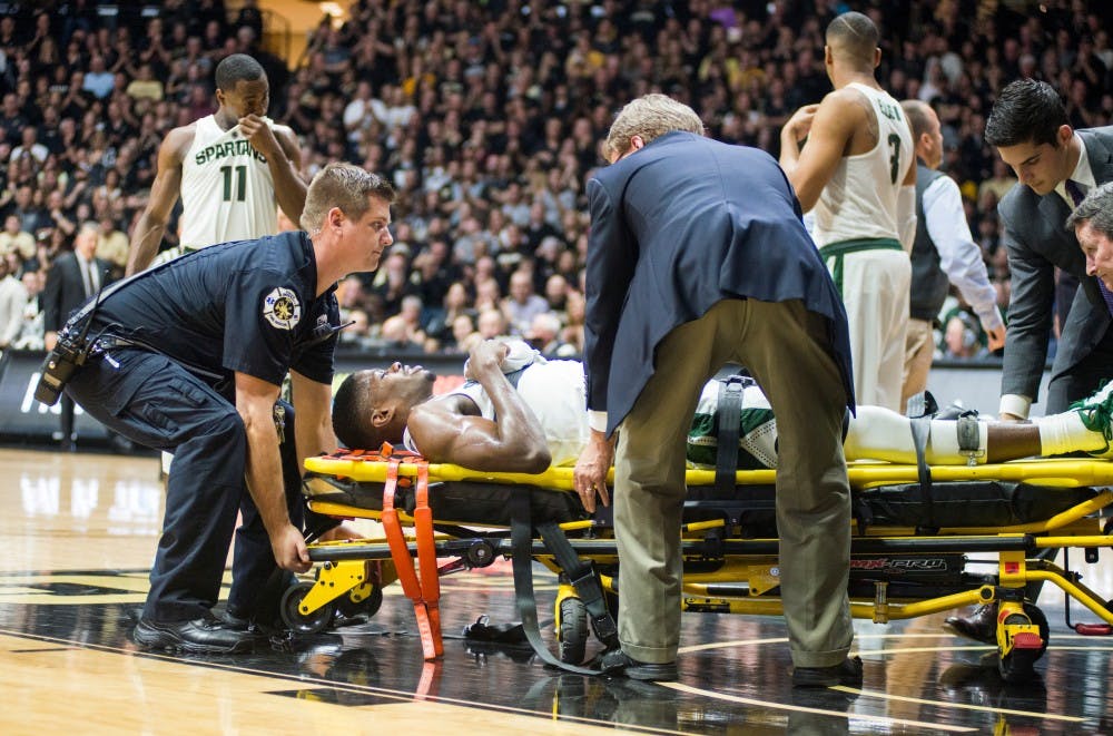 Red-shirt senior Eron Harris (14) gets taken away on a stretcher after a bad fall during the second half of the men's basketball game against Purdue on Feb. 18, 2017 at Mackey Arena in Lafayette, Ind. The Spartans were defeated by the boilermakers, 80-63.