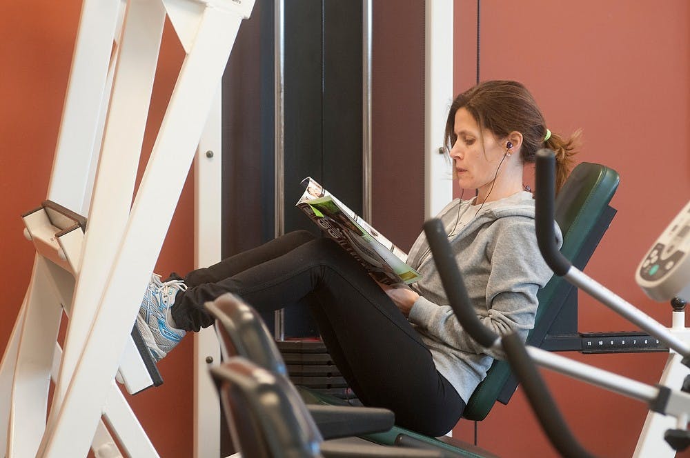 	<p>East Lansing resident Kerry Frawley exercises Jan. 7, 2014, at the Hannah Community Center. Frawley came with her children so they could play while she worked out. Christina Strong/The State News</p>