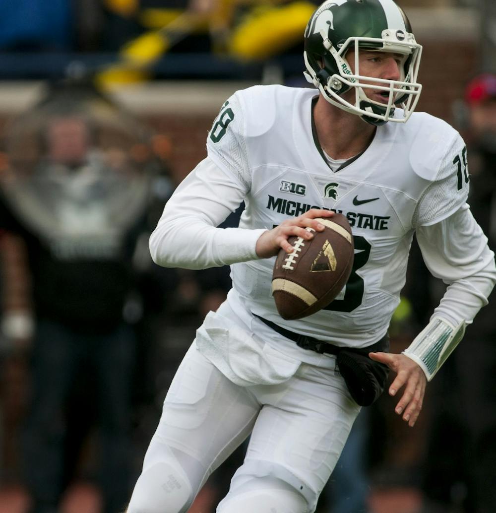 <p>Senior quarterback Connor Cook looks to throw on Oct. 17, 2015 during the first quarter of the game against Michigan at Michigan Stadium in Ann Arbor. The Spartans defeated the Wolverines, 27-23. </p>