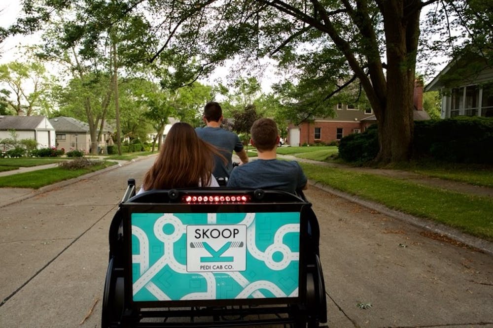 <p>Students get a free ride from one of the pedicabs from advertising management sophomore Josh Cooper's transportation service. Photo courtesy of Skoop, Inc.</p>