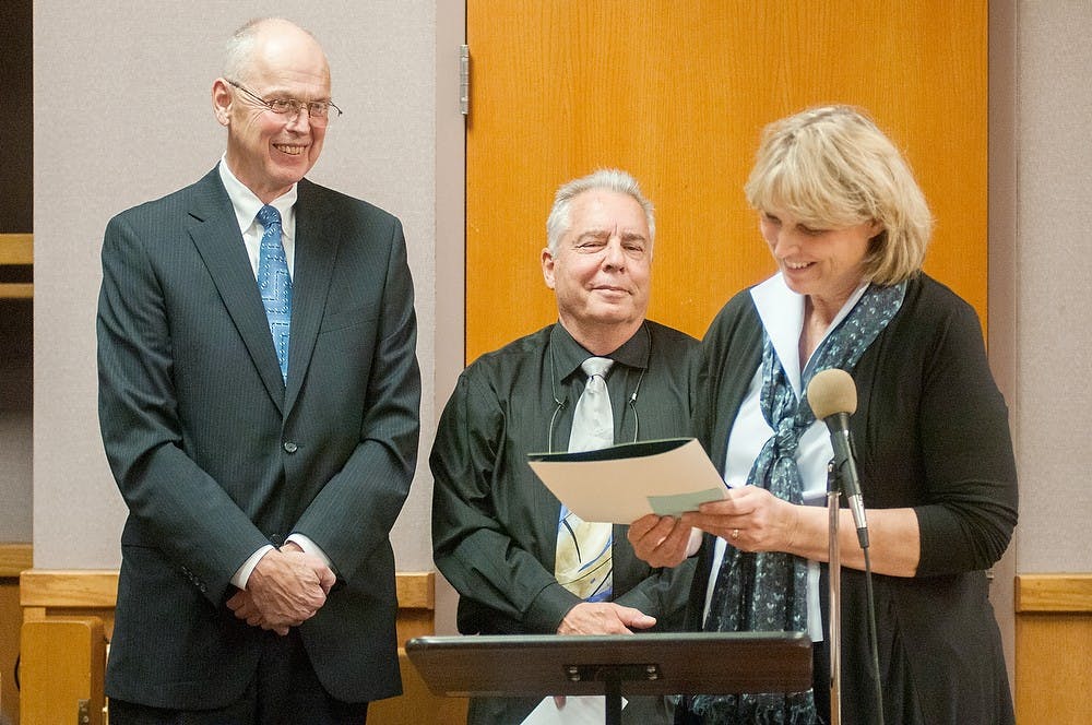 	<p>Mayor Diane Goddeeris, right, delivers a speech honoring Judge David Jordon, left, on Tuesday, Dec. 4, 2012, at East Lansing&#8217;s 54B District Court during a city council meeting. Judge Jordon has served as East Lansing&#8217;s 54B District Court judge for 23 years. Julia Nagy/The State News </p>