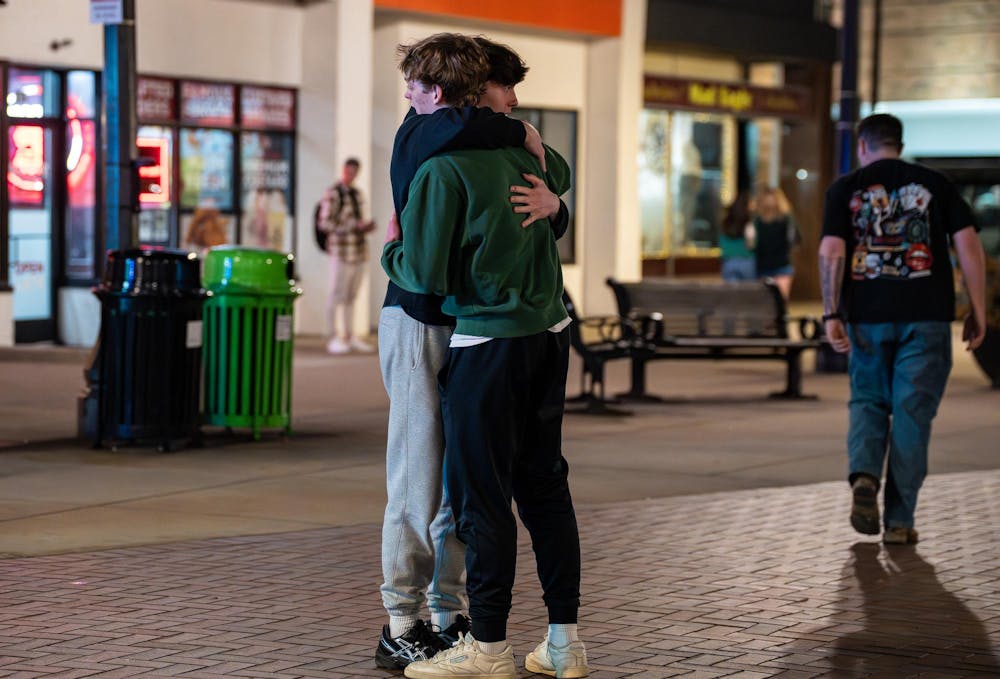 <p>Fans embrace on Grand River Ave. in East Lansing, Michigan, after watching UConn defeat Michigan State in the NCAA men’s basketball tournament regional semifinal game on Friday, March 27, 2026.</p>