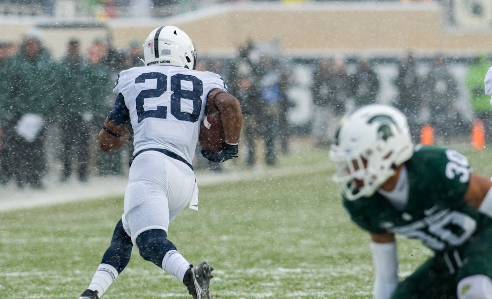 Penn State runningback Devyn Ford (28) runs the ball towards the endzone on Nov. 27, 2021.
