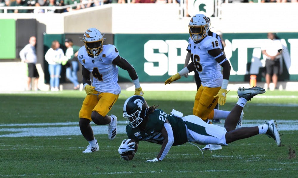 <p>Senior fullback Darrell Stewart Jr. (25) dives for a pass from Lewerke in the second quarter. The Spartans fell to the Sun Devils 10-7 at Spartan Stadium on Sept. 14, 2019.</p>
