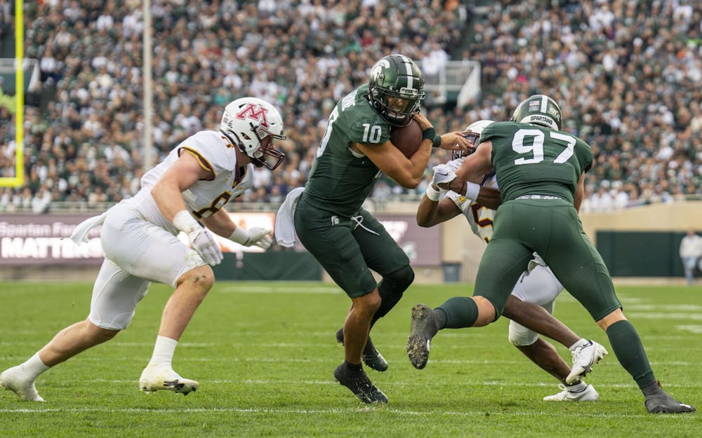 <p>Redshirt junior quarterback Payton Thorne, 10, attempts to break through the Minnesota defense during Michigan State’s match against Minnesota on Saturday, Sept. 24, 2022. The Gophers ultimately beat the Spartans, 34-7.</p>